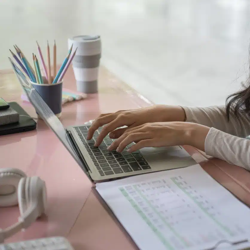 Accounting professional doing manual entry on laptop.